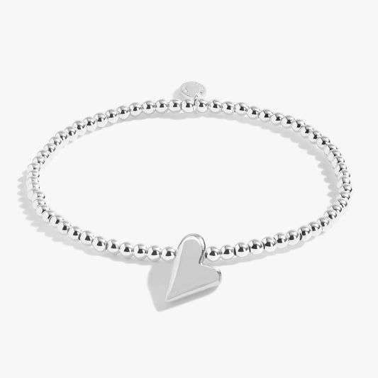 A silver beaded bracelet with an irregular heart