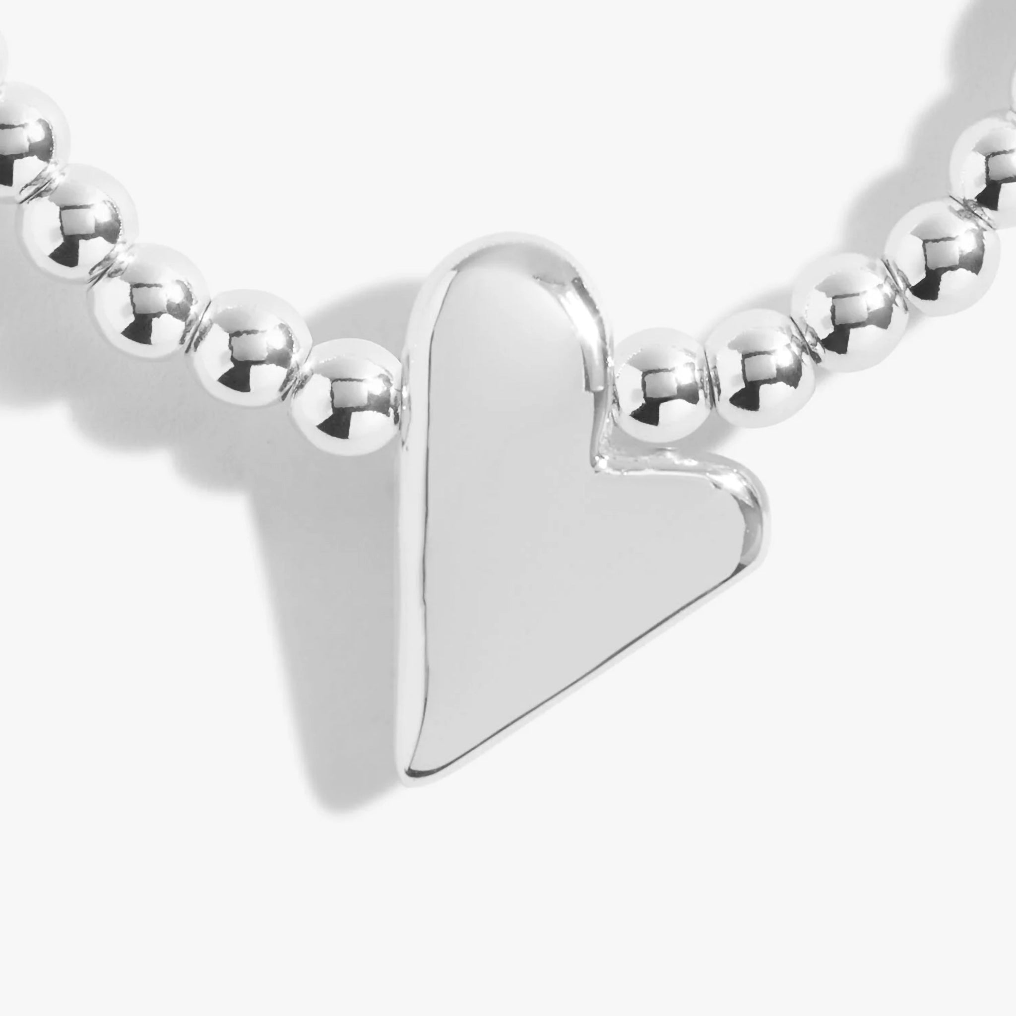 Detail of a silver beaded bracelet with an irregular heart