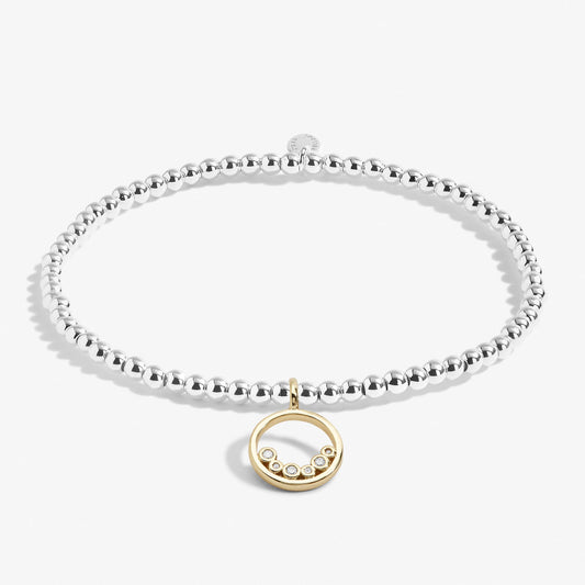 A silver beaded bracelet with a gold goop and CZ stones