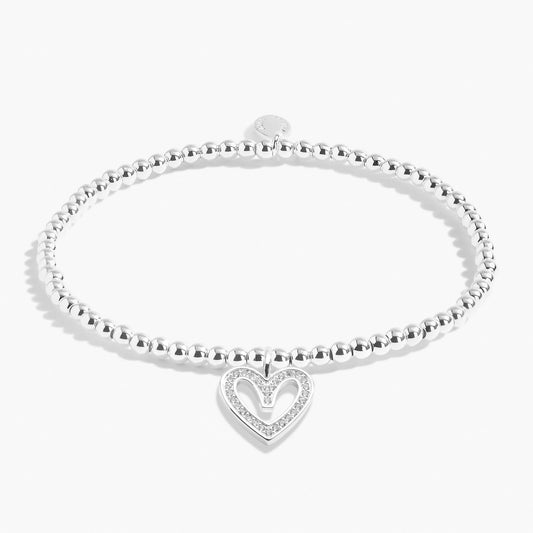 A silver beaded bracelet with a CZ open heart charm 