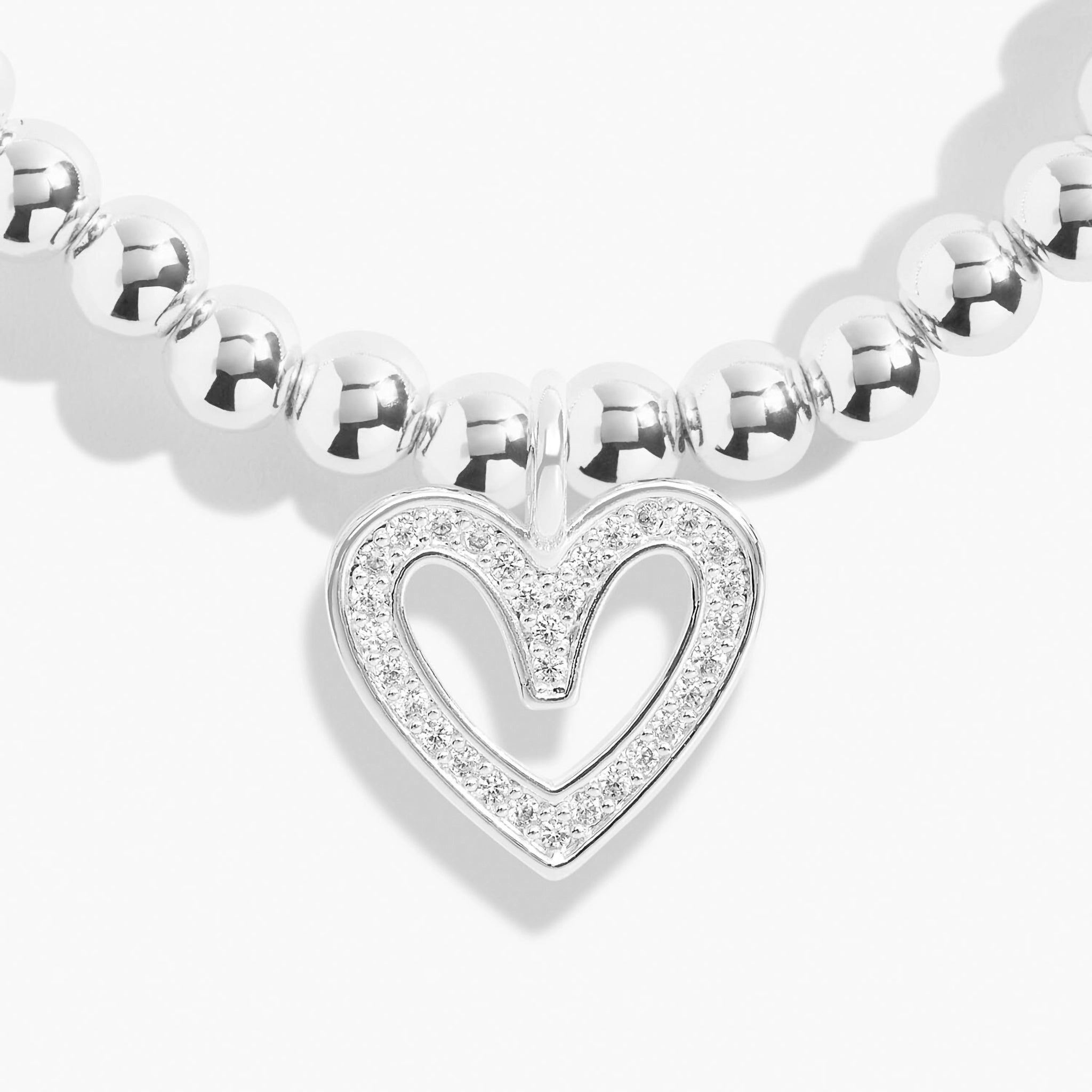 Detailed image of a silver beaded bracelet with a CZ open heart charm
