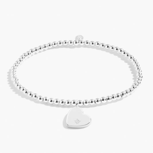 A silver beaded bracelet with a silver heart with a CZ stone 