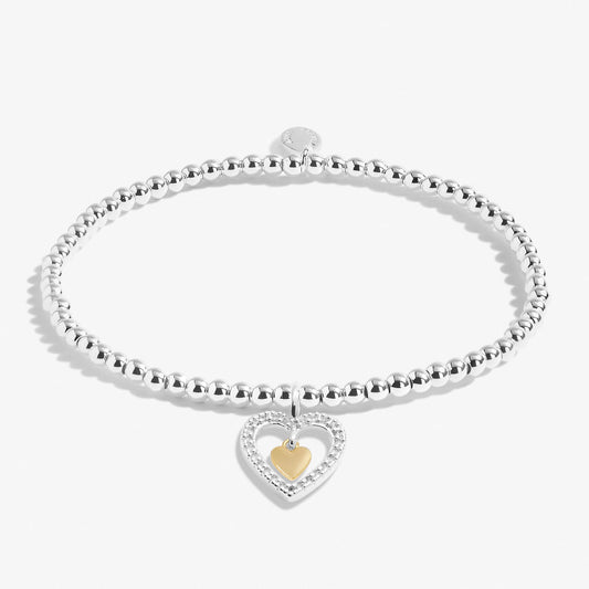 A silver beaded bracelet with silver CZ and gold hearts charm 