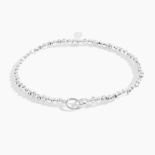 A silver beaded bracelet with silver interlinking circles 