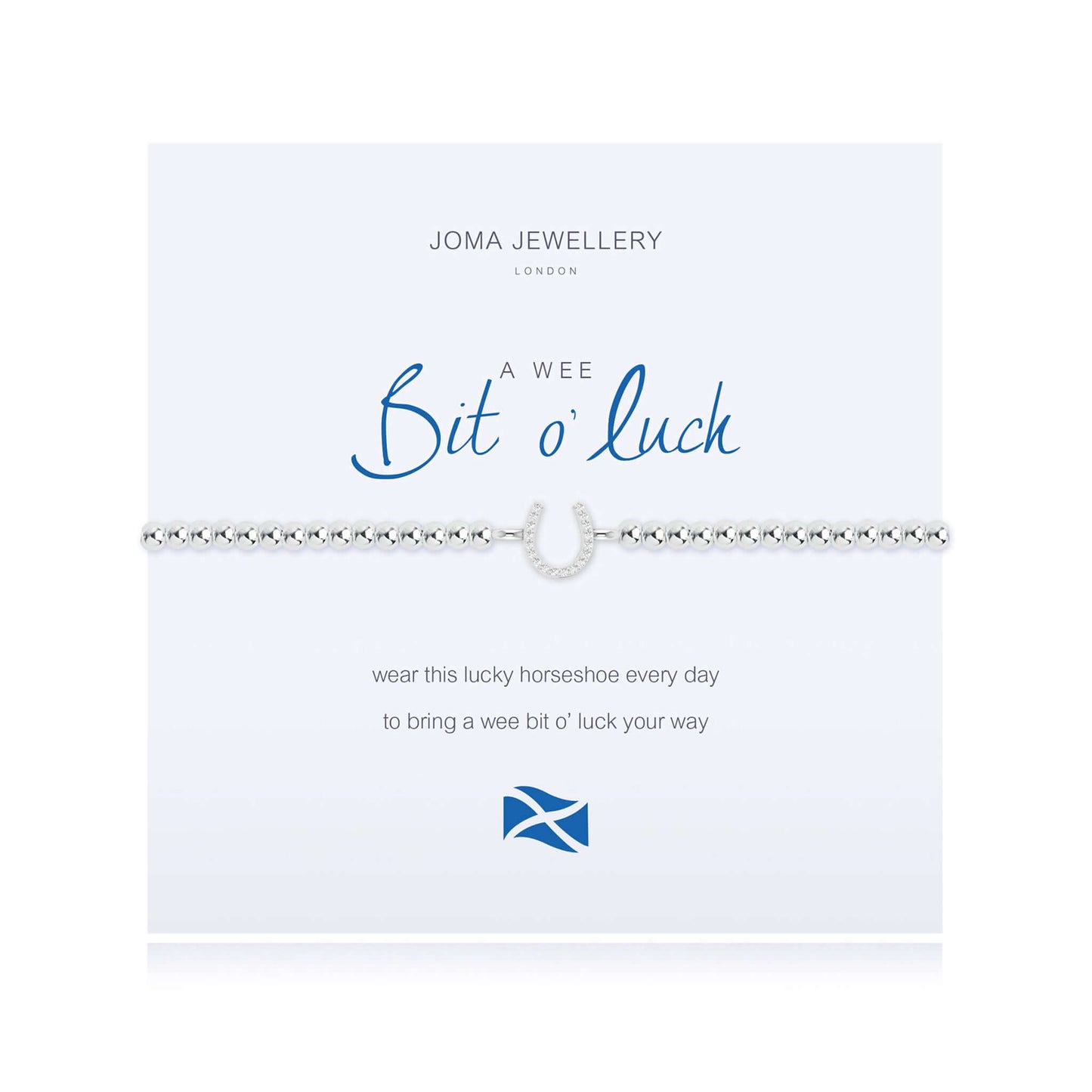 A silver bracelet with a CZ horseshoe charm on a card with the sentiment 'Bit o' Luck'