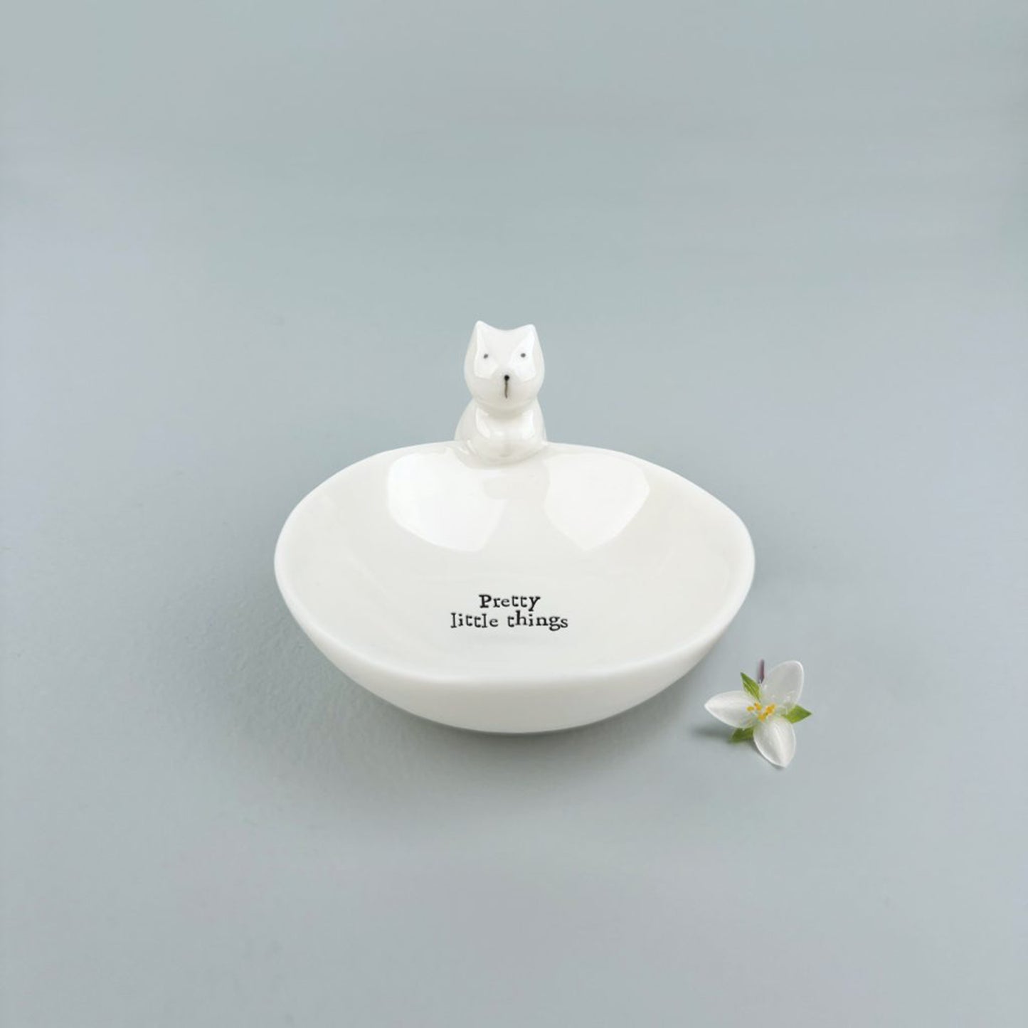 A white percaline trinket bowl with a little cat and the words 'Pretty little things'