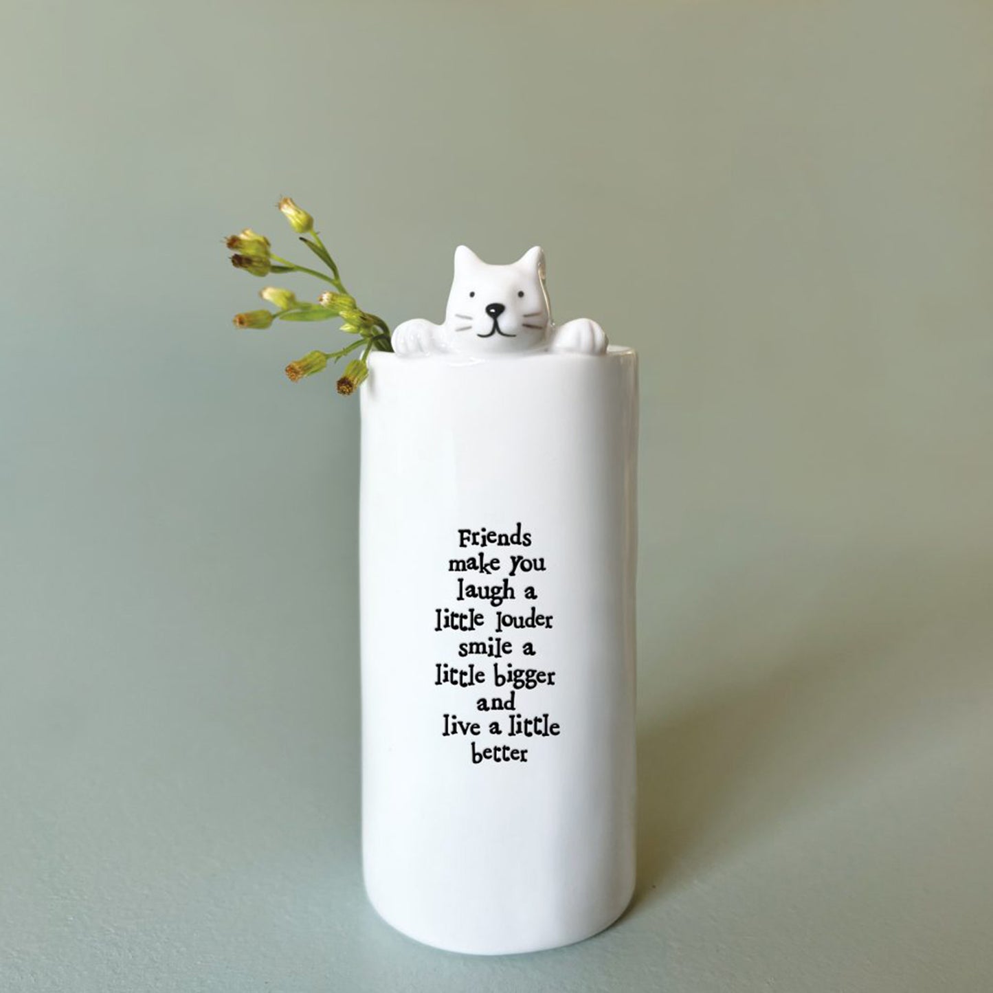 A cylinder white vase with a little cat and phrase