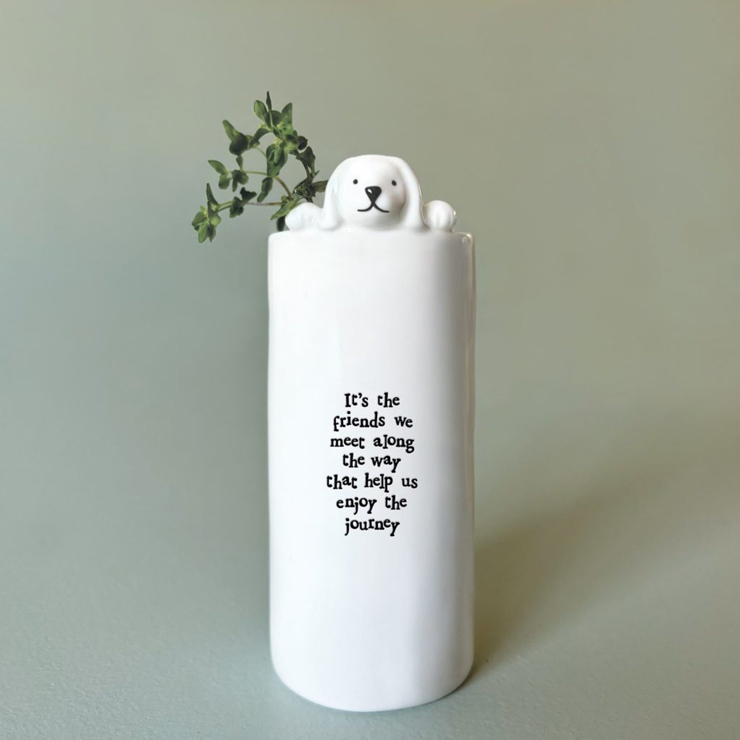 A cylinder white vase with a little dog and phrase