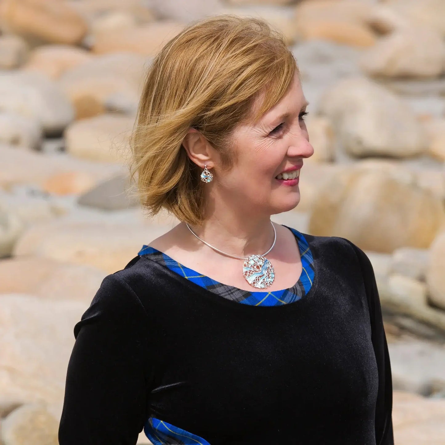 Model wearing earrings and necklet of the Arctic Stream jewellery collection by Sheila Fleet