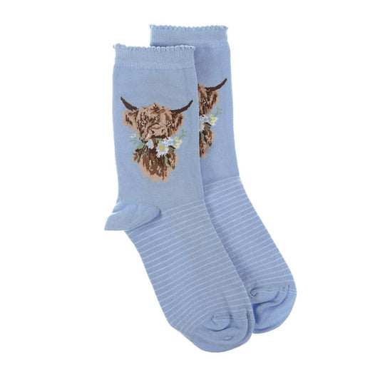 Pair of light blue socks with a highland cow picture and white stripes and small ruffled tops