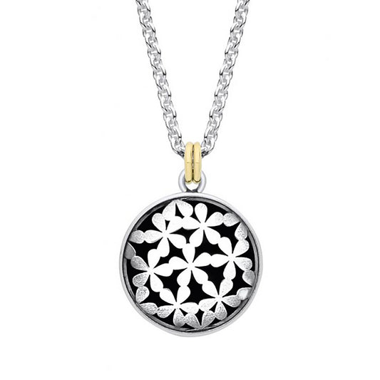 Large silver coin shaped pendant with tiny flower design and oxidisation with a gold bail on a silver chain