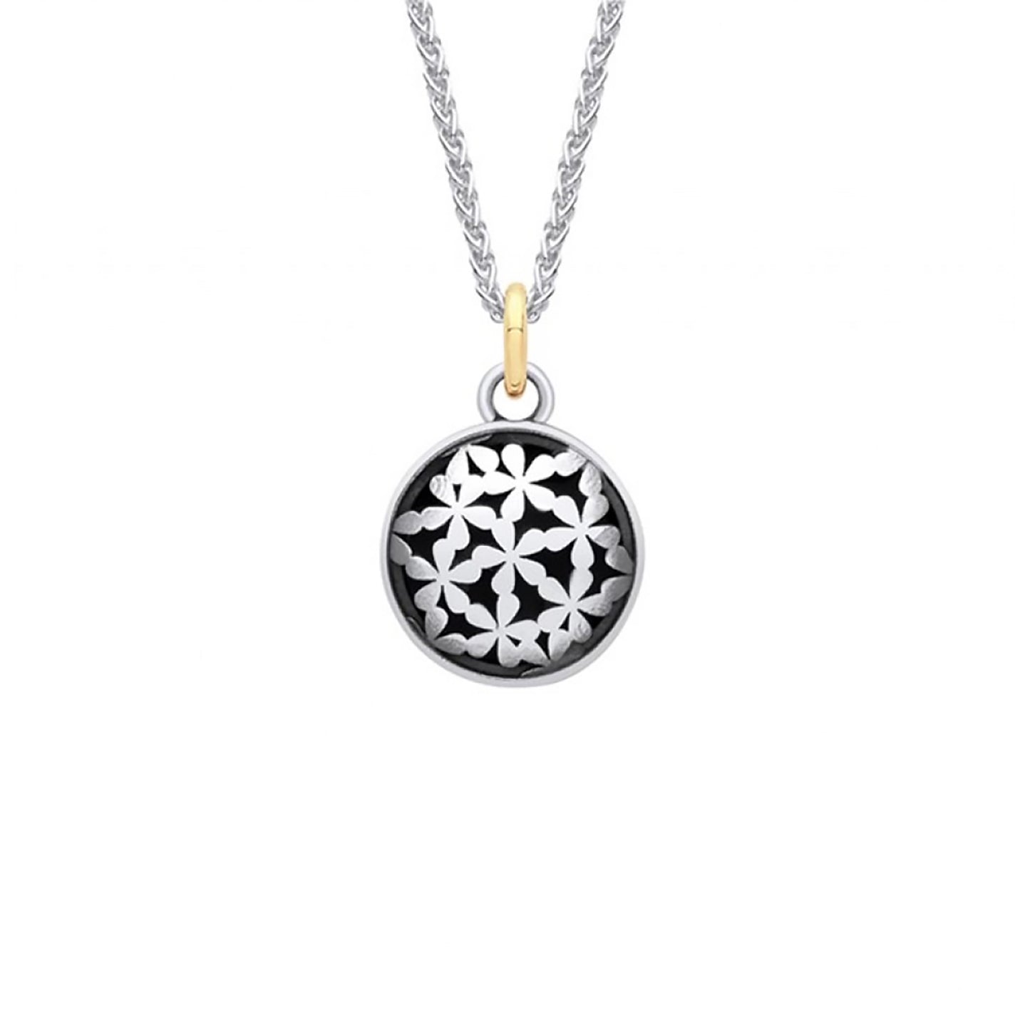 Silver coin shaped pendant with tiny flower design and oxidisation with a gold bail on a silver chain