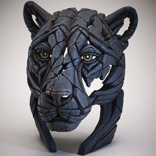 Side view of a modern sculpture of a black panther bust with brown eyes