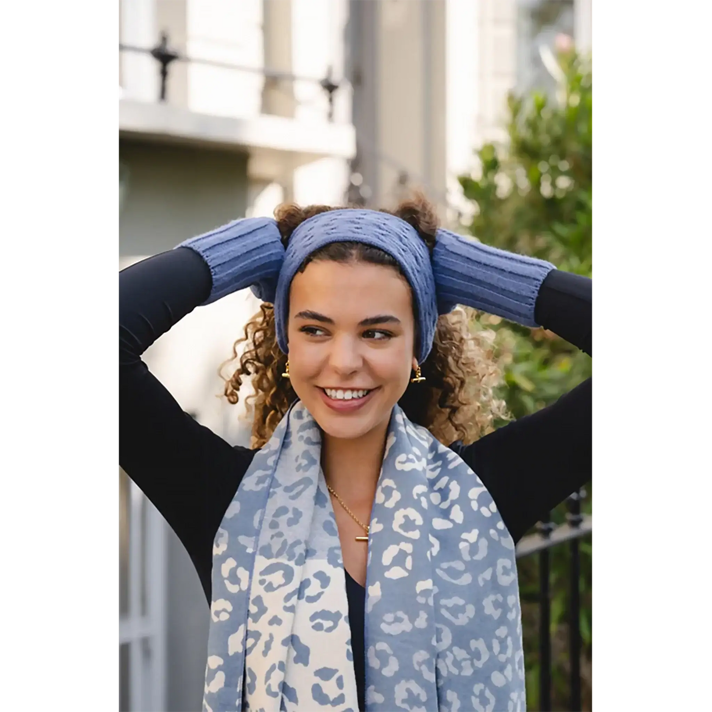 Model wearing a cable knitted blue headband