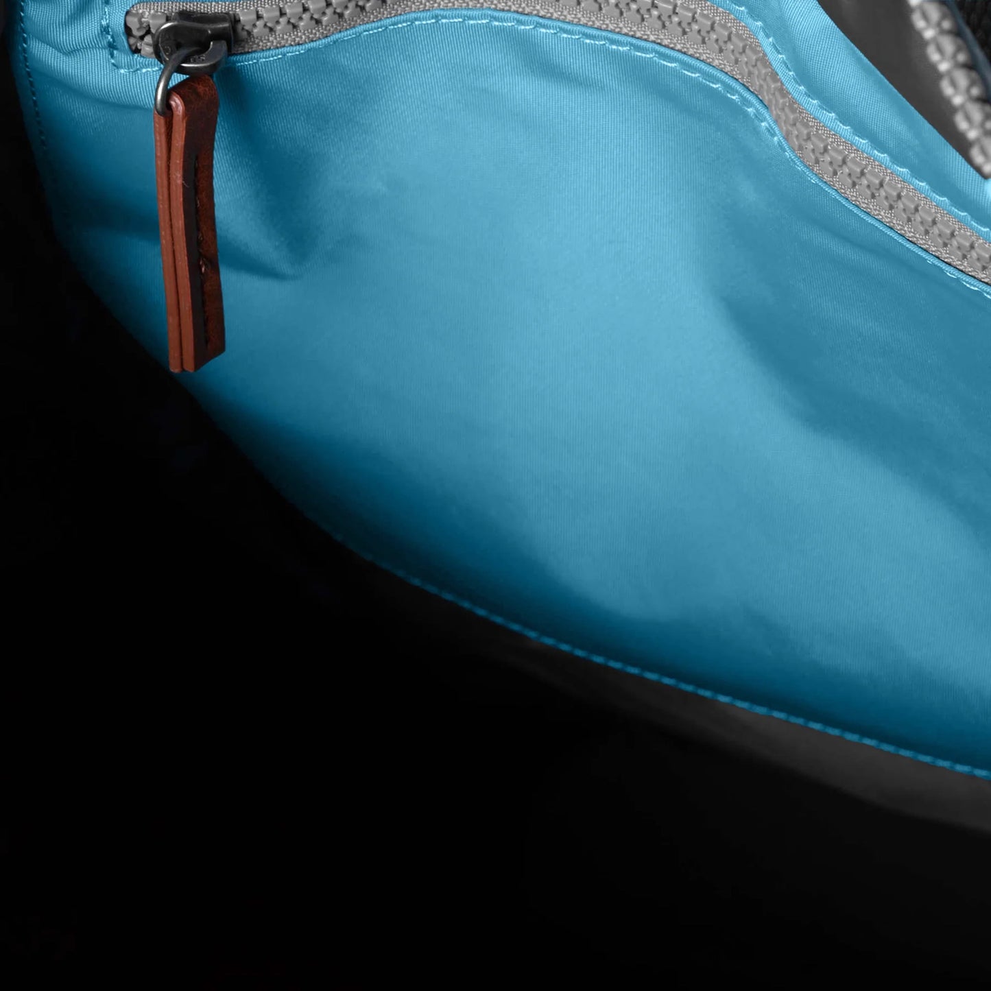 Light blue rolltop backpack with internal zip pocket