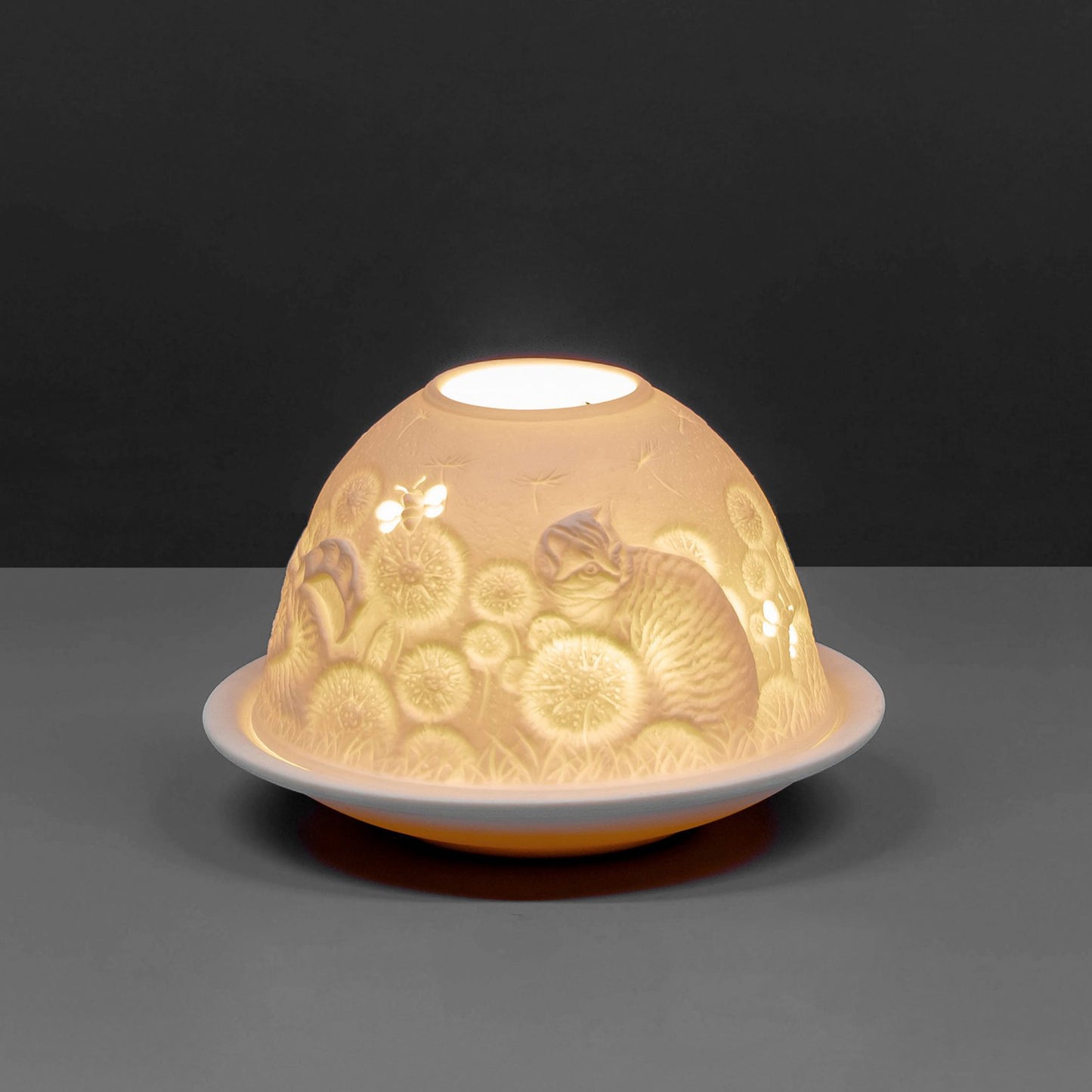 White porcelain tall dome candle holder with engraved cat and bees design lit up 2