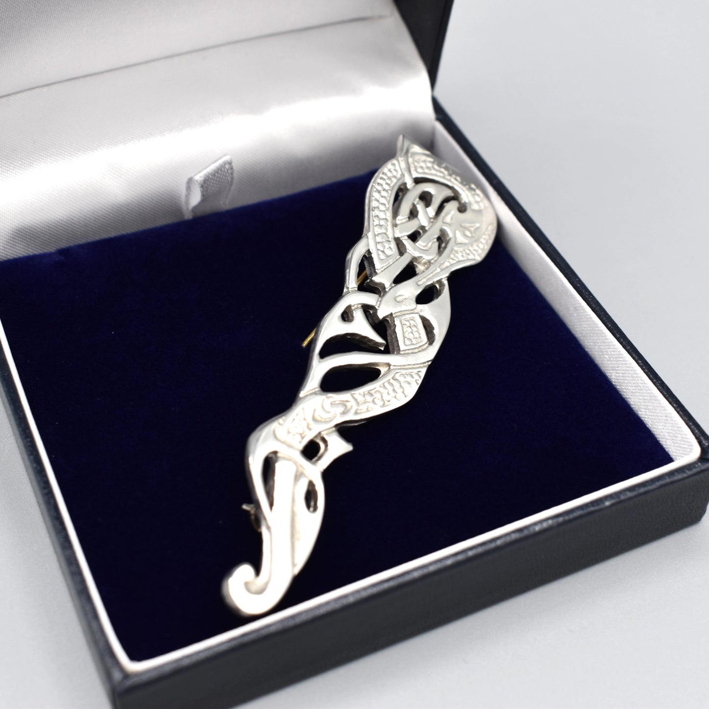 Kilt pin with abstract Celtic design with a twisting dragon-like shape box detail
