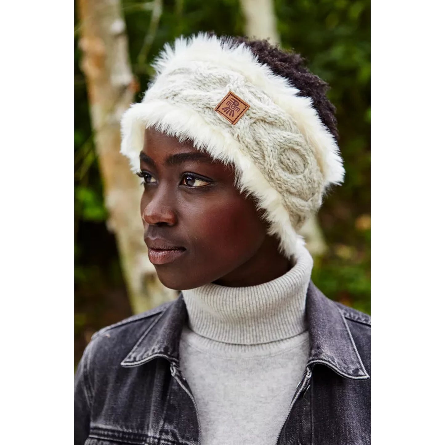 Model wearing a faux fur lined grey cable knit headband
