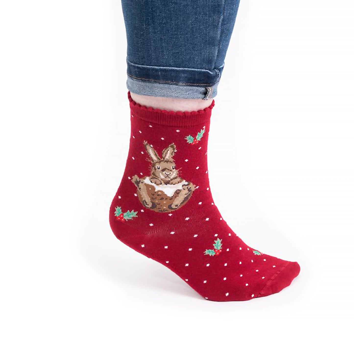 Model wearing pair of Christmas socks in red with a rabbit in a Christmas pudding