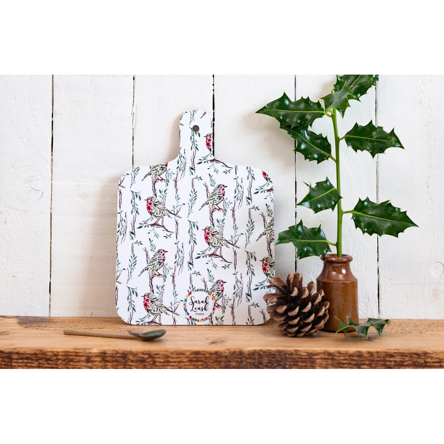 A double sided melamine chop board with the small side of the Christmas robin design