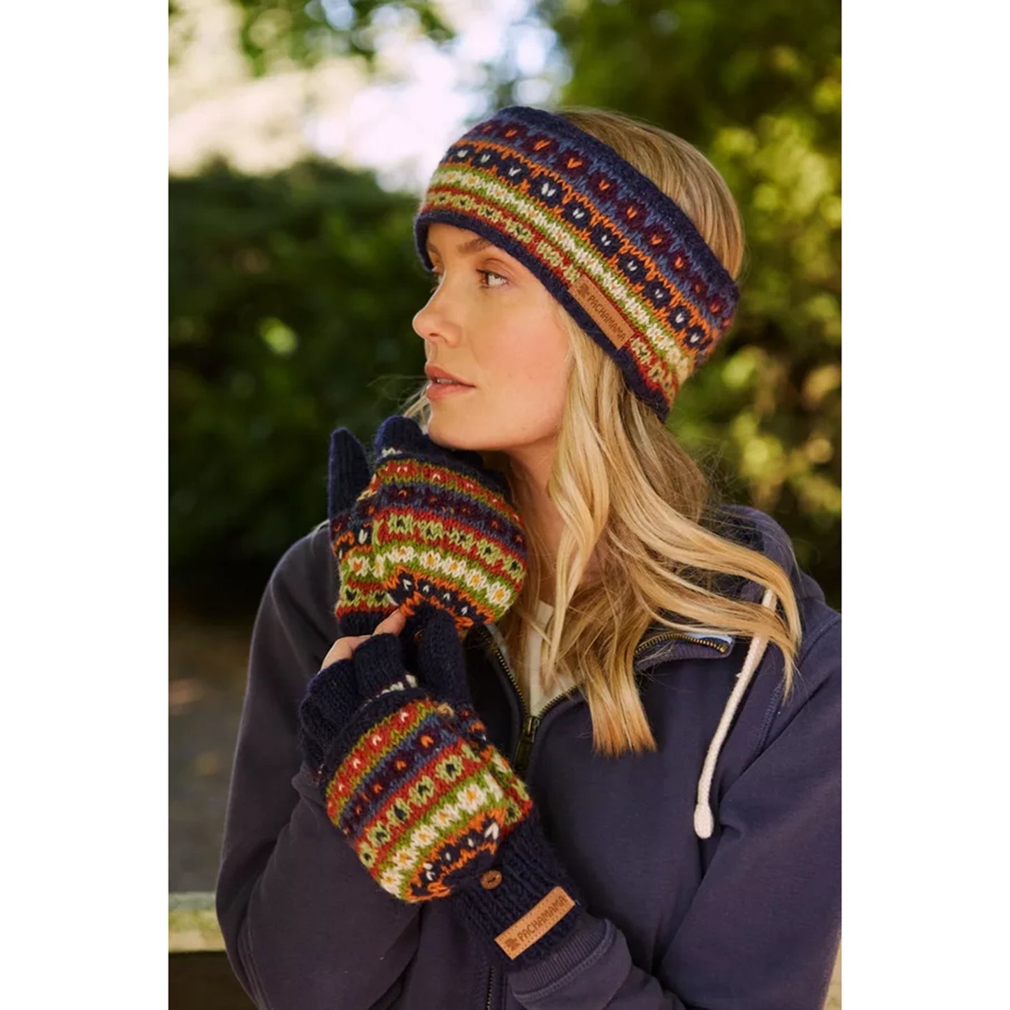 Model wearing a dark blue repeat patterned headband with different coloured stripes