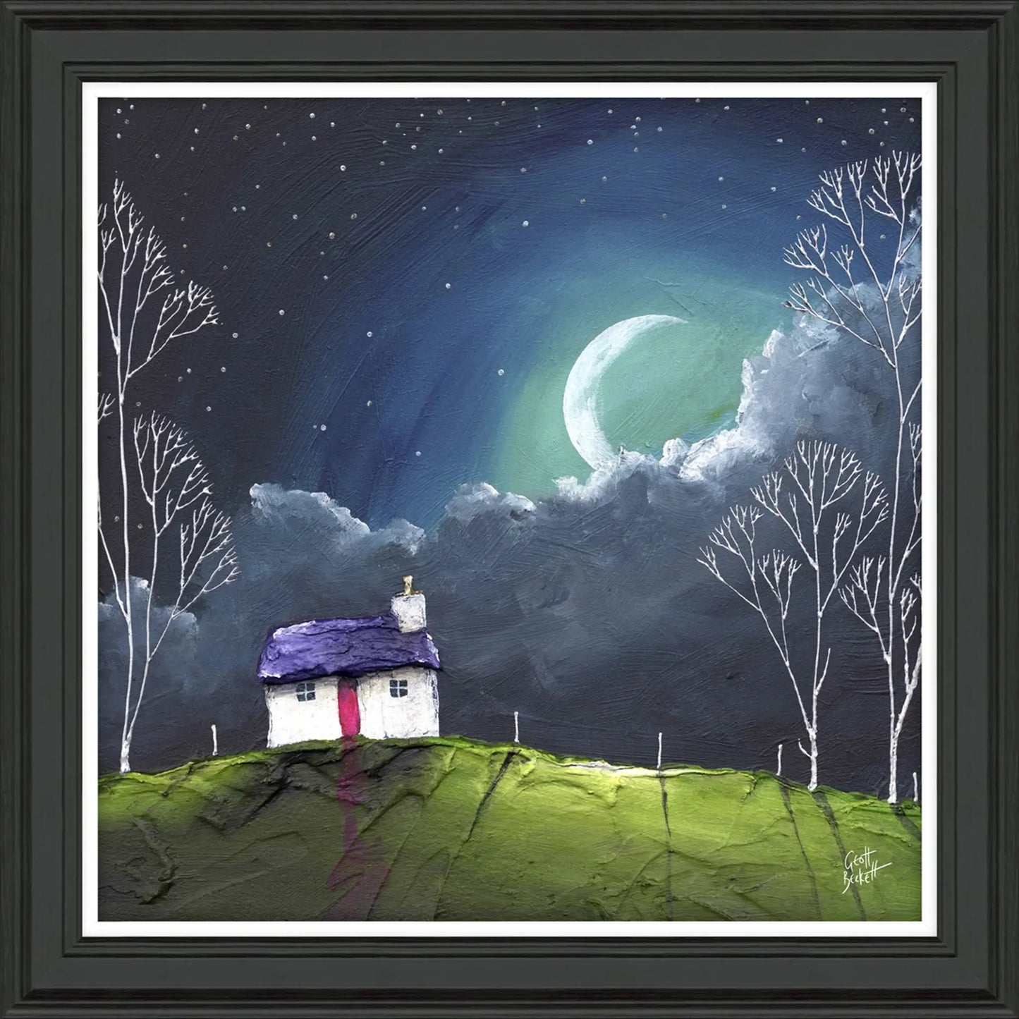 A framed print featuring a cottage at night with a glowing moon by artist Geoff Beckett