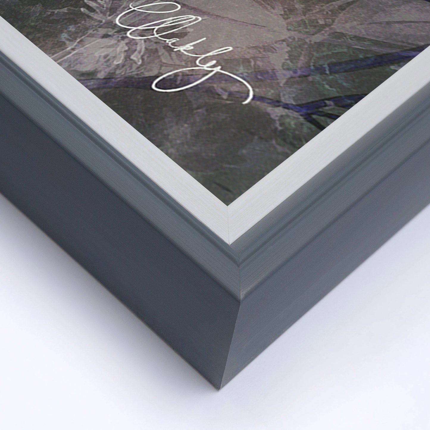 Close-up of bottom left corner of simple modern grey frame.