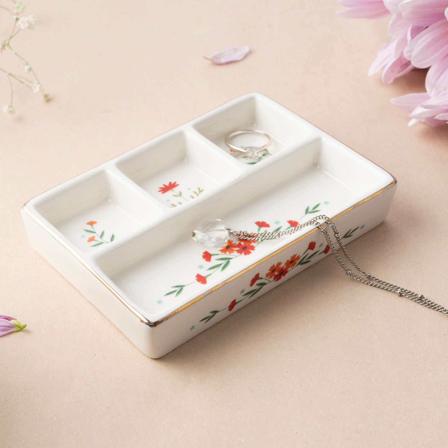 A ceramic jewellery tray with four compartments and floral design lifestyle