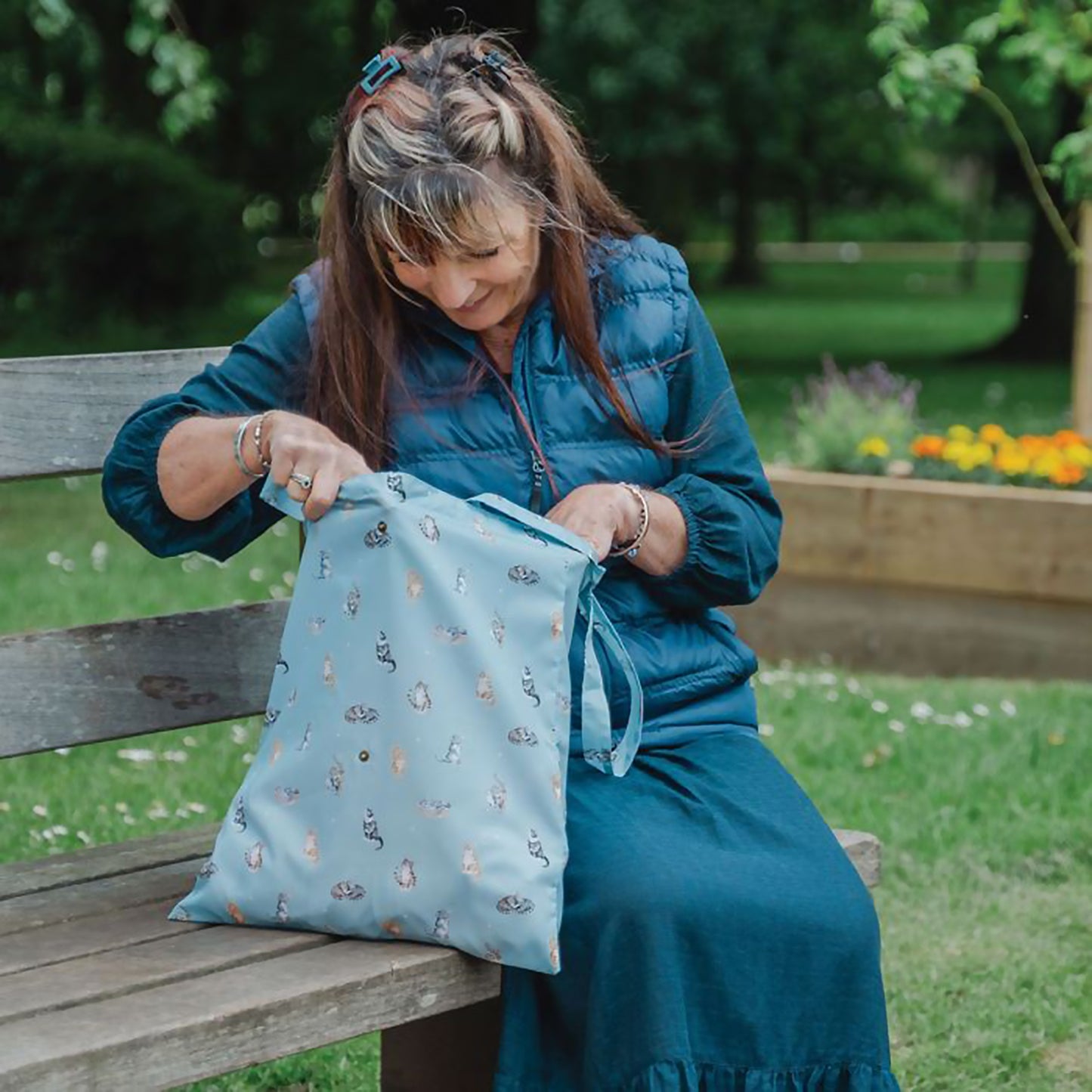 Model with blue shopping tote bag with repeat cat design