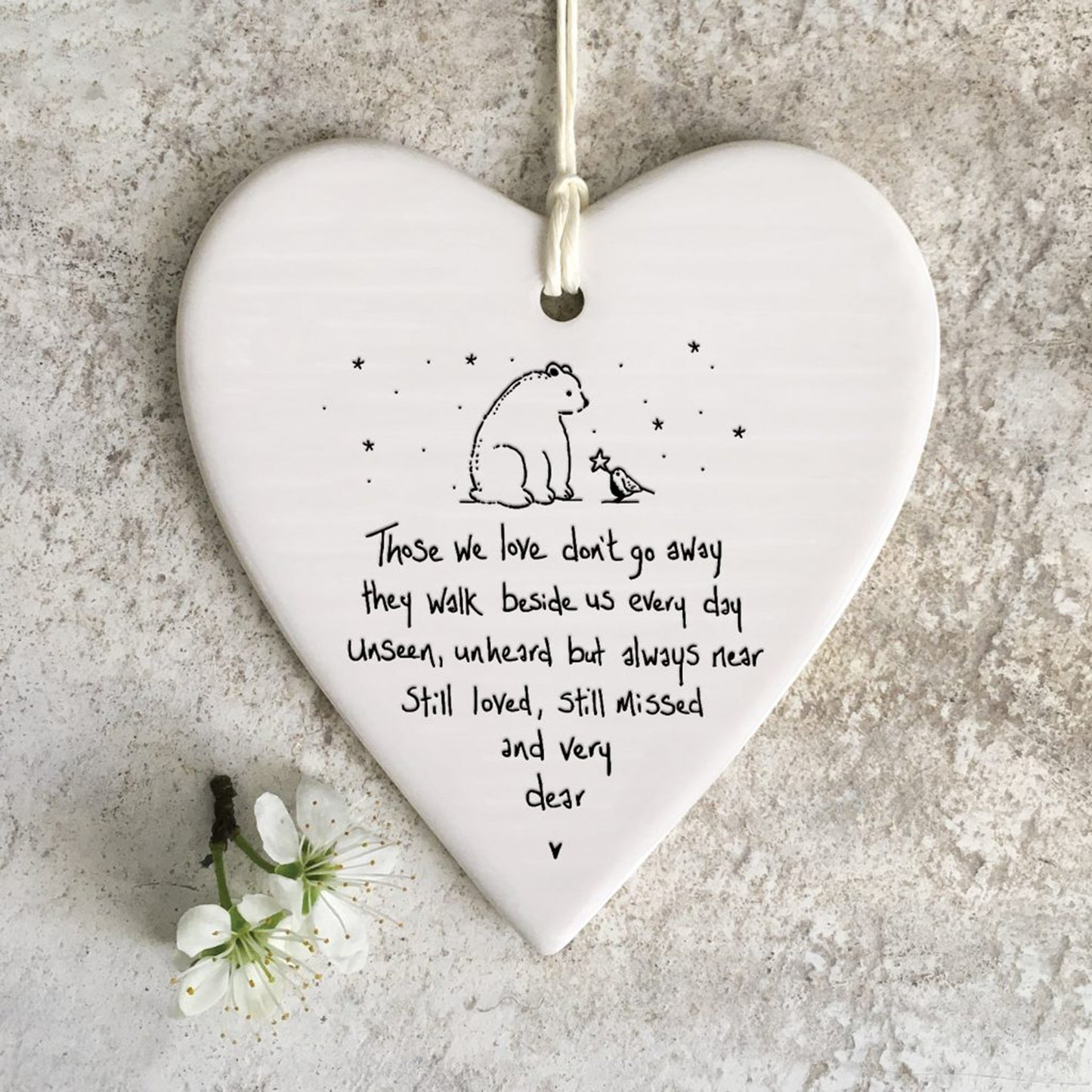 White ceramic heart with a bear and bird illustration and a poem
