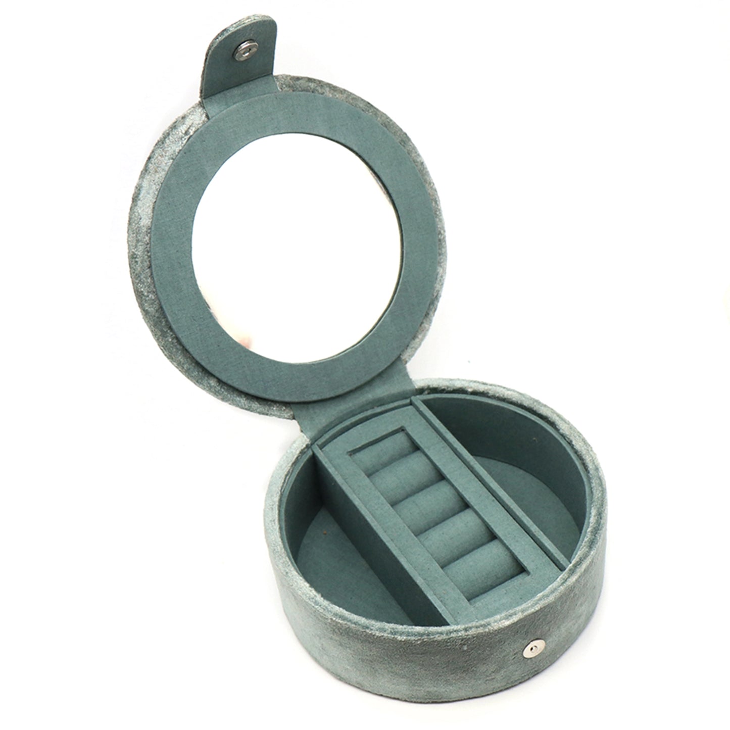 A round seafoam green velvet jewellery box with two open compartments and a ring roll