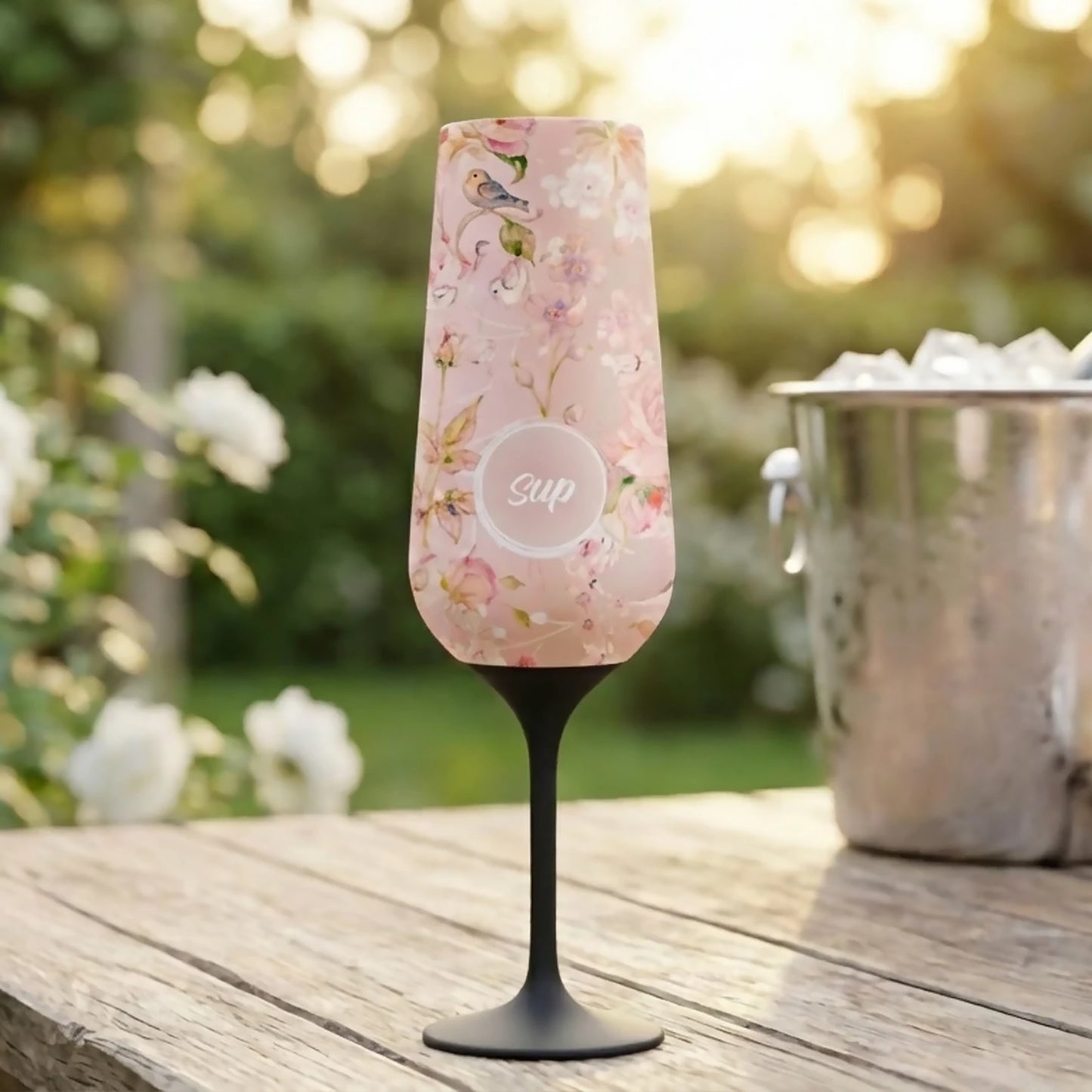 Stainless steel insulated pink floral champagne flute with Sup logo lifestyle
