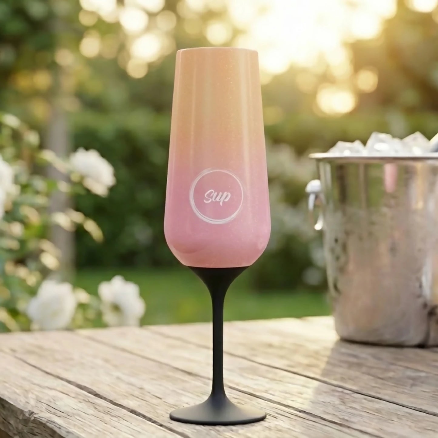Stainless steel insulated pink and gold ombre champagne flute with Sup logo lifestyle