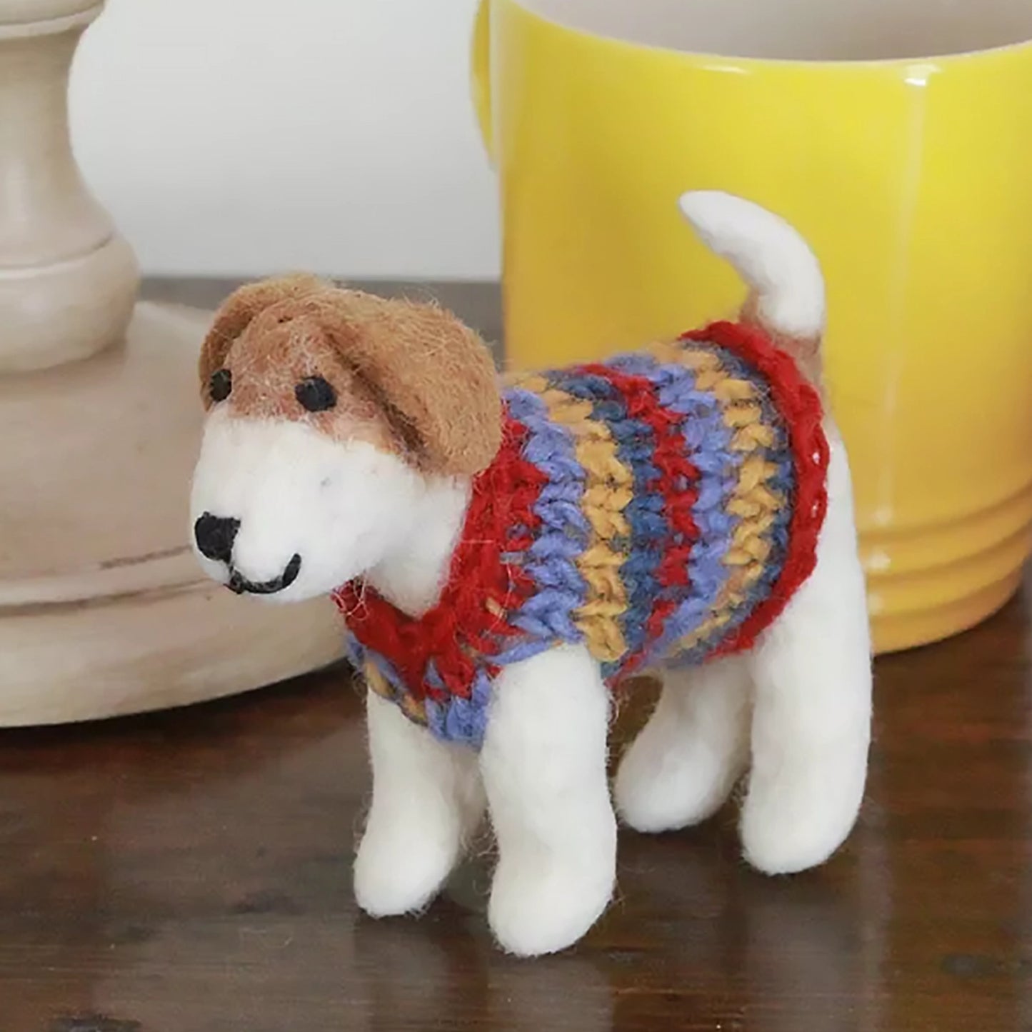 A jack russel terrier wool figure in a striped jumper