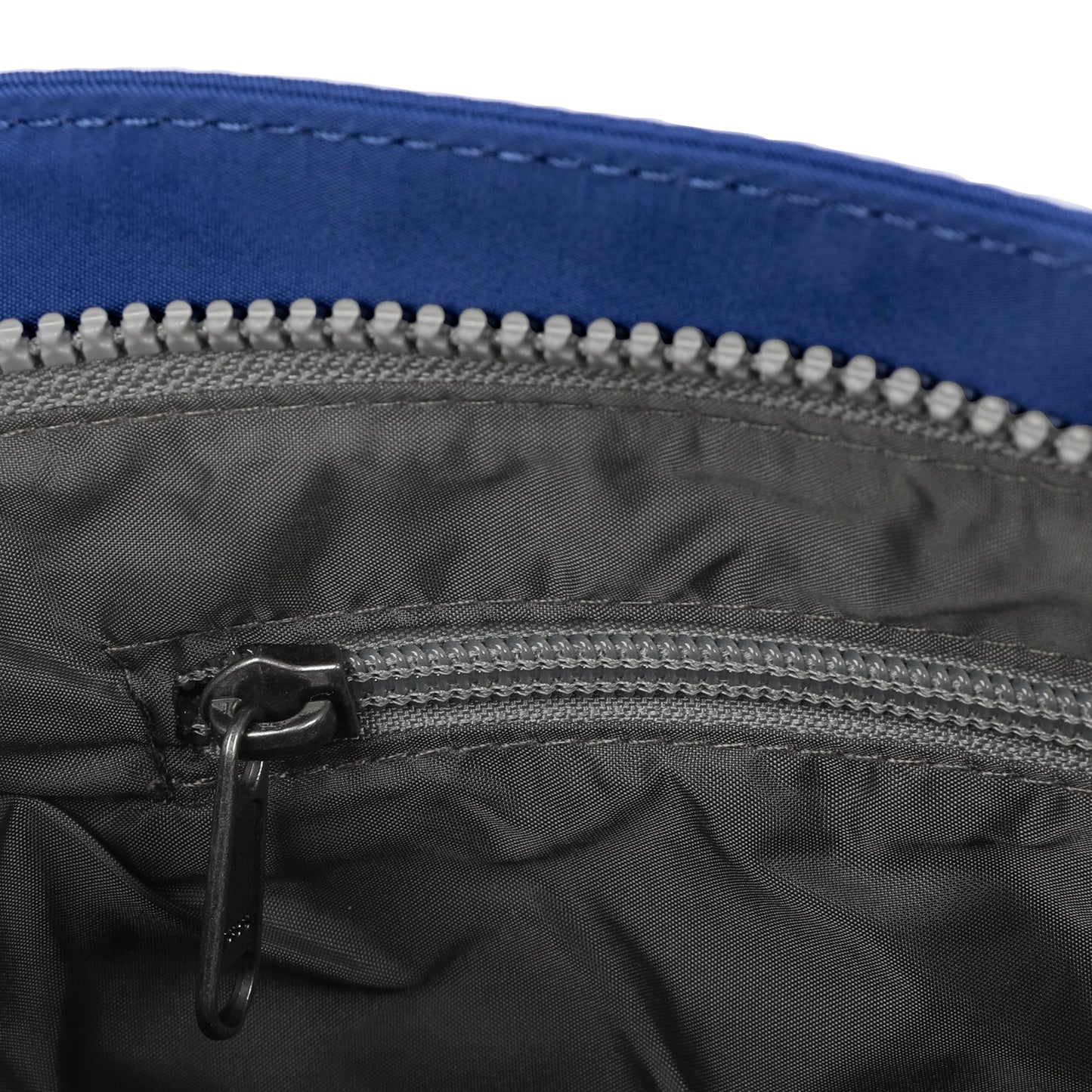 Grey nylon interior zip of crossbody bag