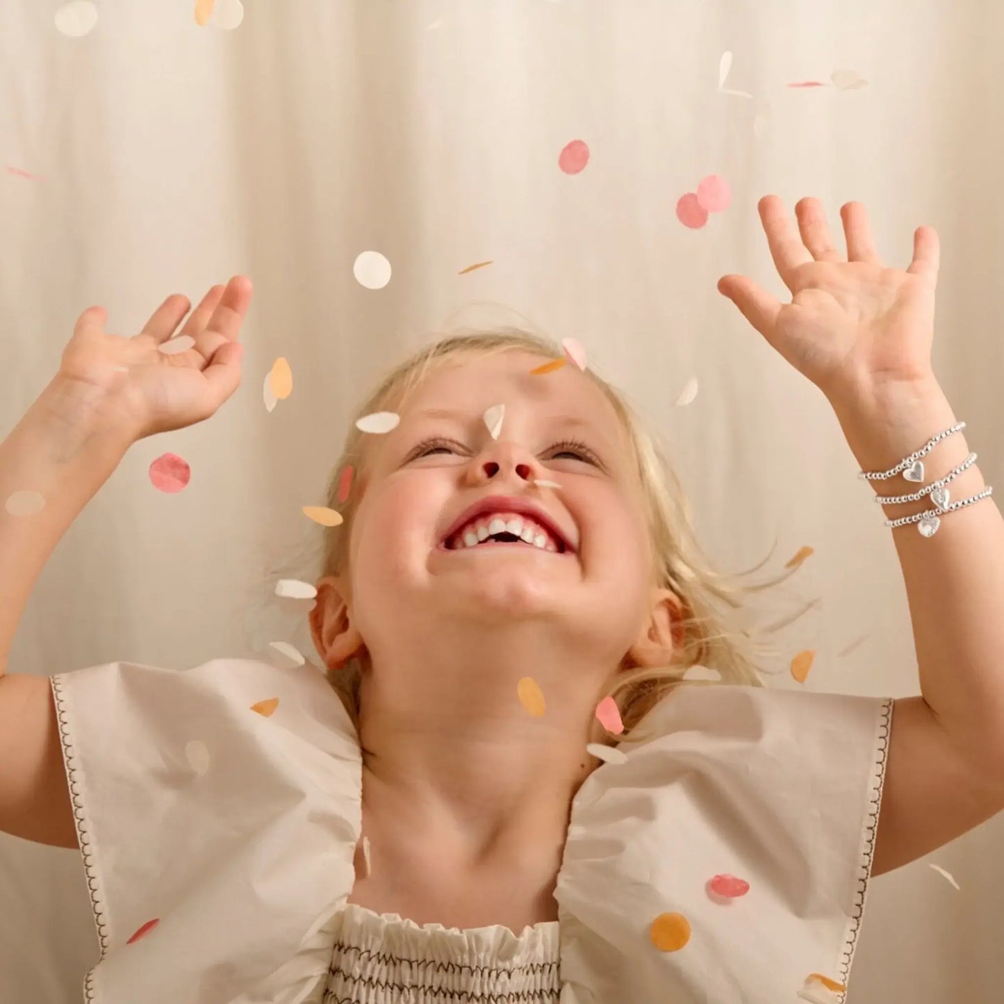 Child modelling Joma jewellery bracelets from their kid's confetti collection
