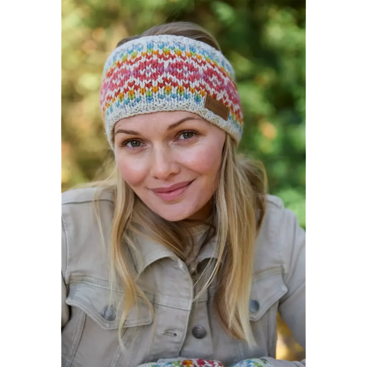 Model wearing knitted oatmeal headband with rainbow chevron heart fair isle pattern
