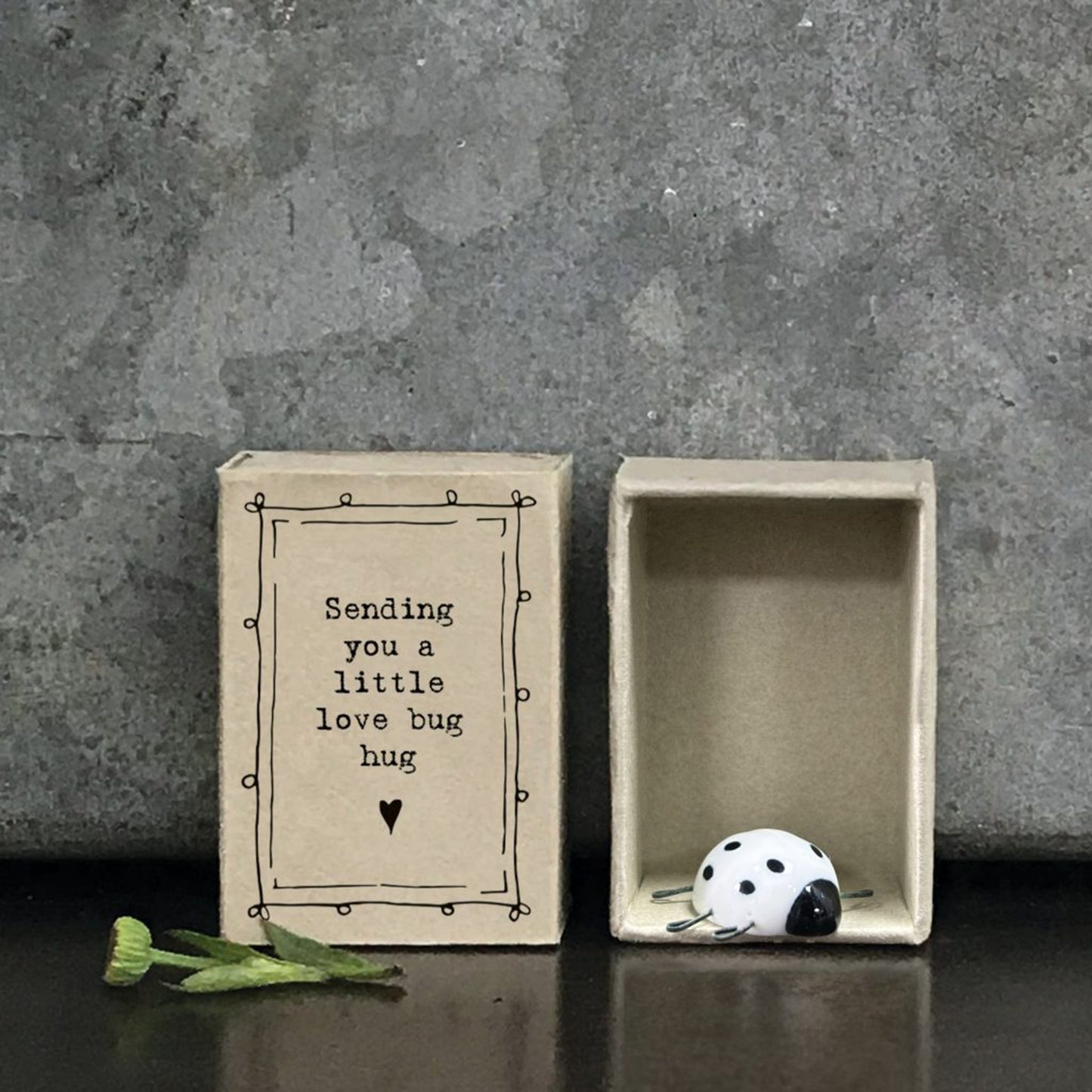 Little spotted love bug figurine in a matchbox