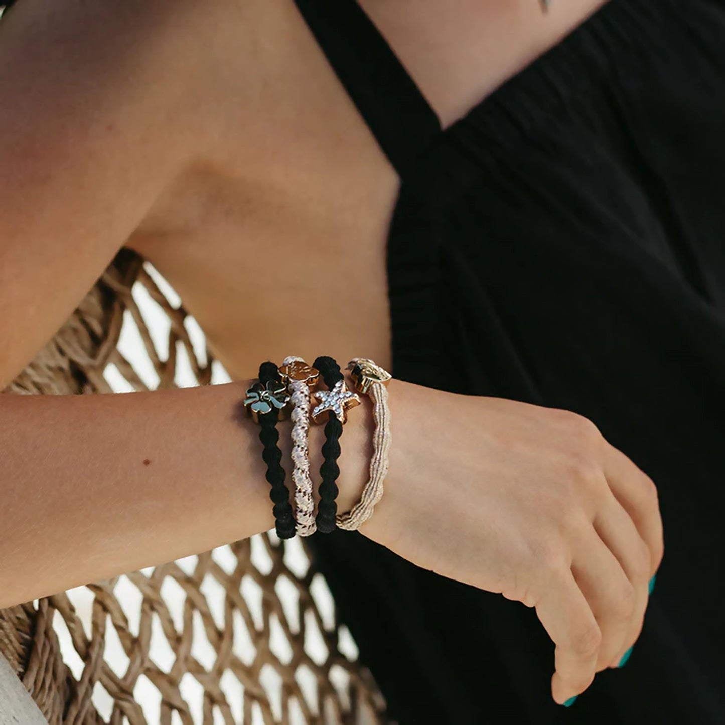 Model wearing elastic bubble hair band in metallic gold with gold heart charm