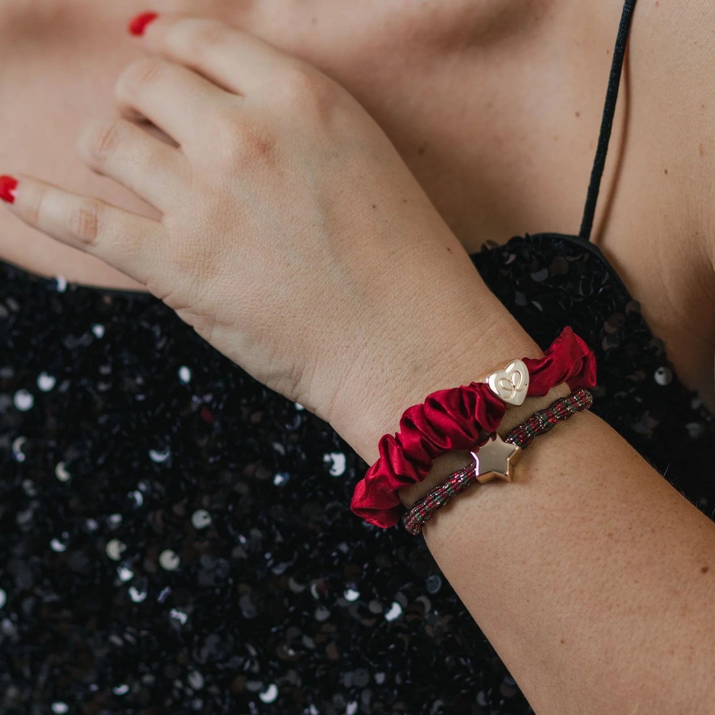 Model wearing a metallic tri coloured bubble shaped hair tie with gold star charm as a bangle