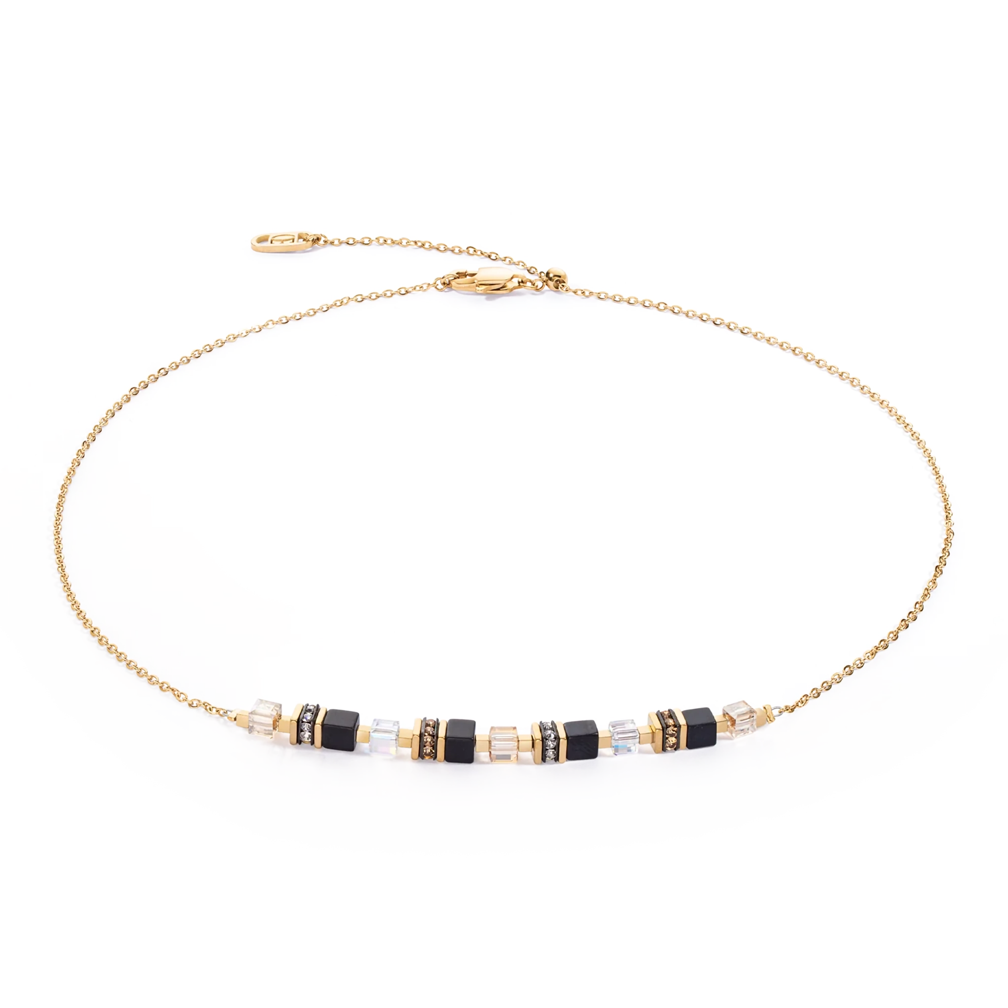 A gold chain necklace with black cube shaped stones