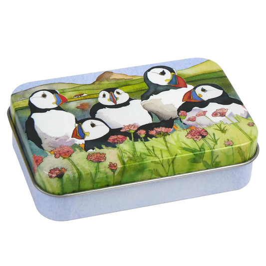 A hinged top tin with a watercolour illustration of Puffins on a loch background