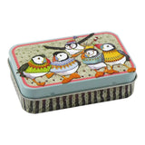 A mini hinged lidded tin covered in illustrations of puffin birds in woolly jumpers