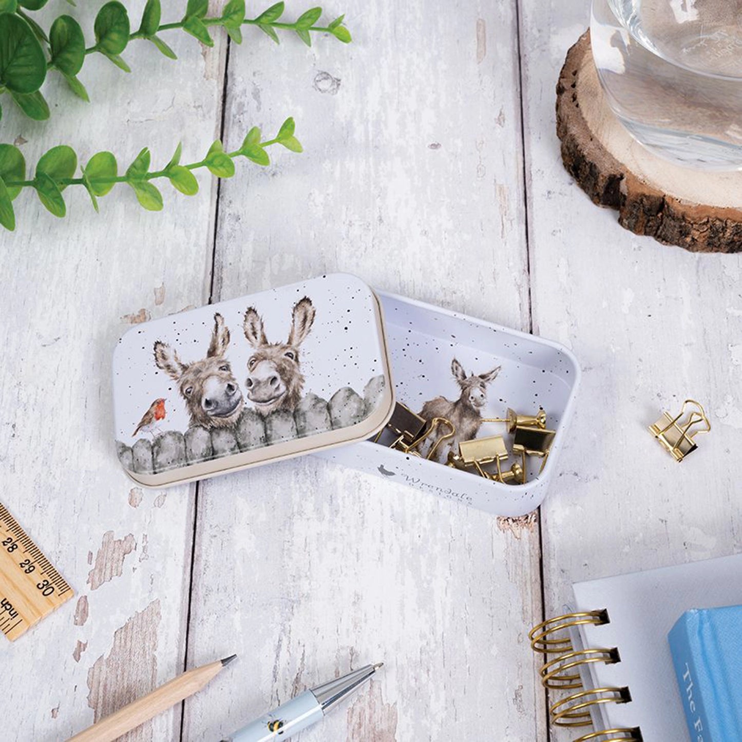 Mini tin fully illustrated with artwork of donkeys by Hannah Dale lifestyle