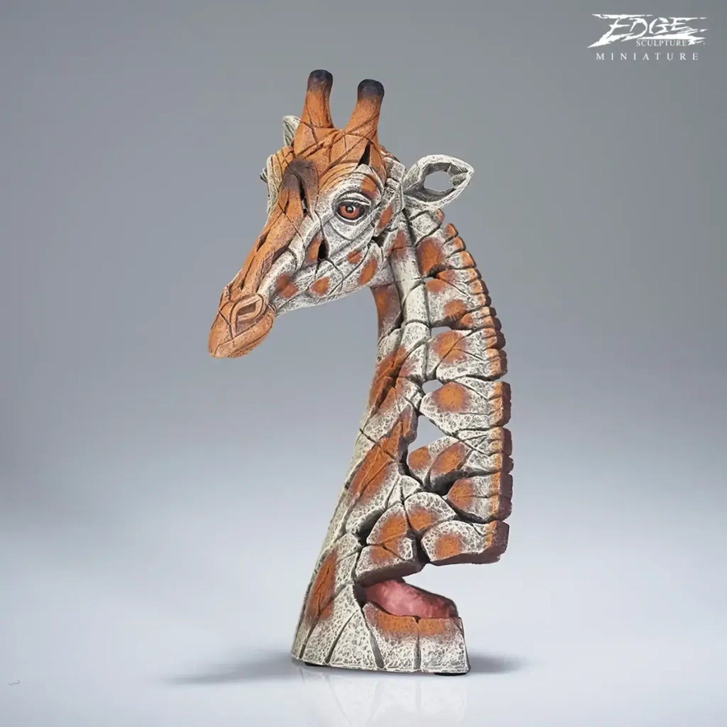 A textured and painted giraffe head bust sculpture side view