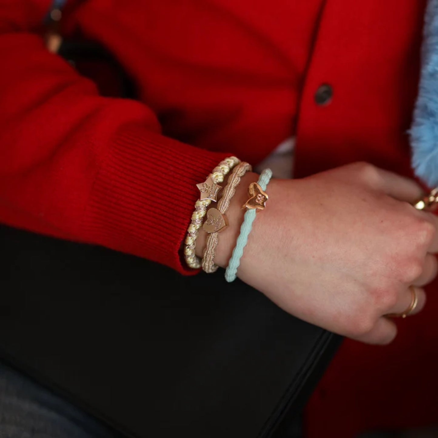 Model wearing elastic bubble hair band in mint with gold butterfly charm as bracelet