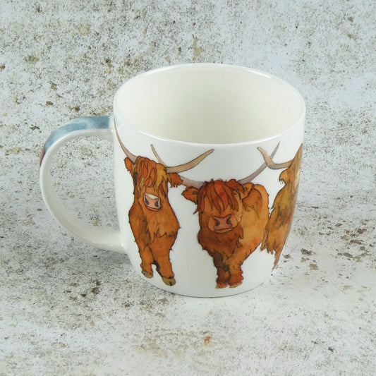 A white china mug featuring a row of highland cows lifestyle image