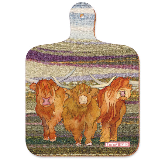 A paddle shaped serving board featuring three Highland cows on a felted landscape background