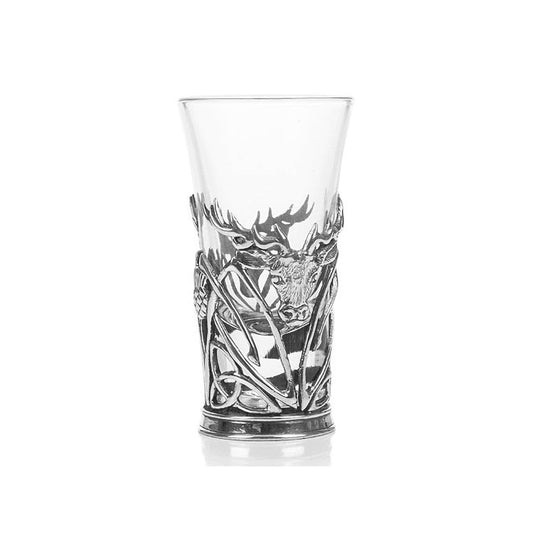 A shot glass with pewter base featuring a stag head with trinity knots and thistles