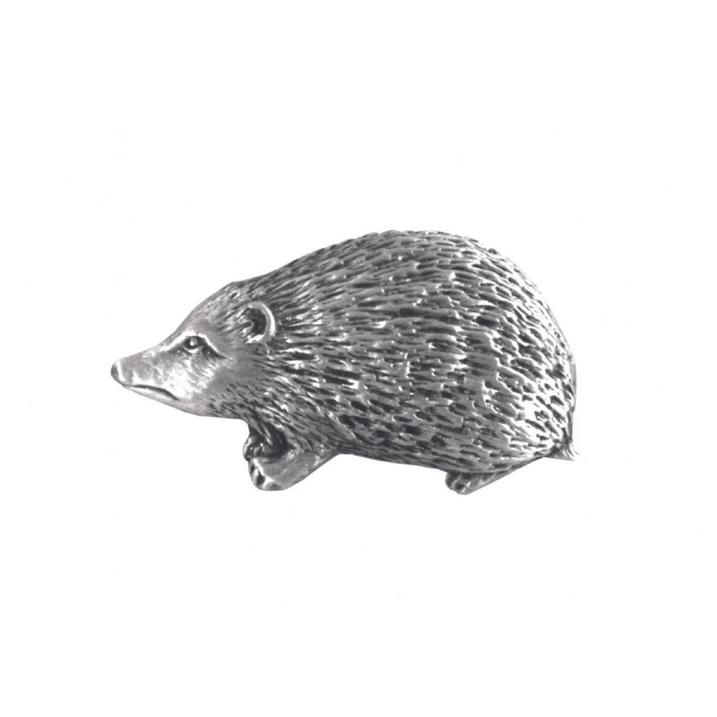 A pewter pin shaped like a hedgehog with fine details